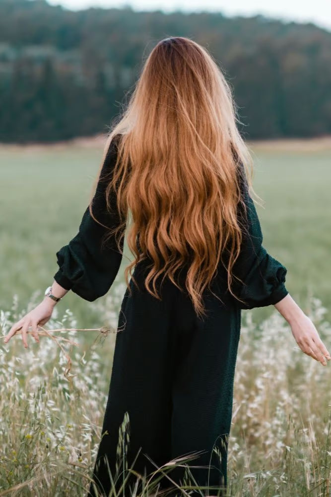 Woman walking through grasses in nature